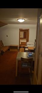ein Zimmer mit einem Tisch und mehreren Betten darin in der Unterkunft Big Apartments in Kopaonik