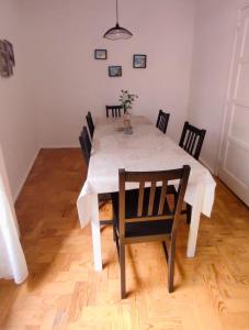 a dining room table with chairs and a white table cloth at Casas da Biquinha in Sintra