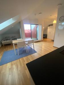 a kitchen and dining room with a table and chairs at Cozy And Luxury Private Terrace Apartment in Gothenburg