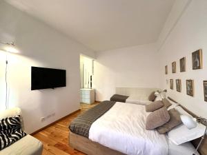 ローマにあるAtelier San Pietroのベッドルーム1室(ベッド2台、薄型テレビ付)