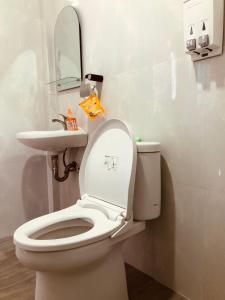 a bathroom with a white toilet and a sink at La Geiro Villa Labuan Bajo in Labuan Bajo +167 photos