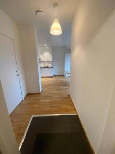 an empty room with a hallway with a kitchen at Luxurious Flat With A Rooftop Terrace in Gothenburg