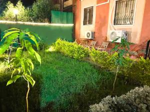 a yard with green plants and a building at Rawdat Zayed Compound in Sheikh Zayed