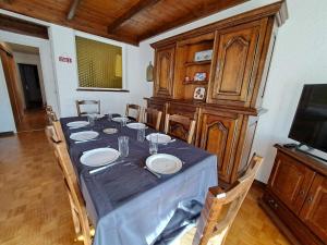 a dining room with a table with plates on it at Location Pra-Loup Vacances in Pra-Loup