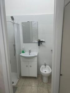 a white bathroom with a sink and a toilet at affittacamere bibiena nel cuore di bologna in Bologna