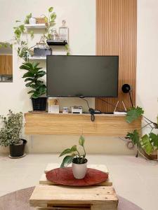 a flat screen tv sitting on top of a table at Cabin in Urban - Urban Deca Homes - Manila in Manila