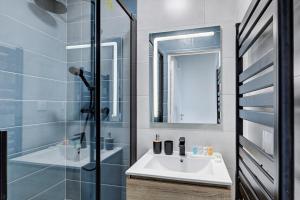 a bathroom with a sink and a shower at 869-Suite Bleuet - Superb Apartment in Montreuil