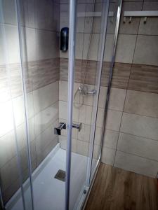 a shower with a glass door in a bathroom at Dreams Low Cost in Madrid
