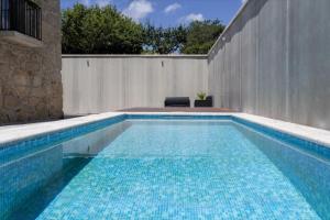 a swimming pool in front of a fence at Casa Da Eira in Vila Real