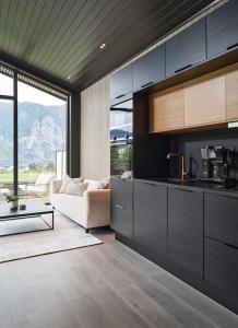 a living room with a couch and a kitchen at Koie Deluxe II in Stranda