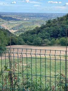 a fence with a view of a field behind it at Casa Borgo Pietro in Galzignano