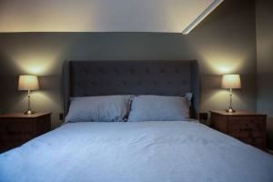BuckinghamshireにあるThe Nest - cosy and quiet 1 bed centralのベッドルーム1室(大型ベッド1台、ランプ2つ付)
