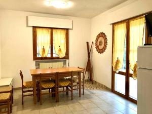 uma sala de jantar com uma mesa de madeira e cadeiras em Holiday home in Rosolina Mare 24967 em Rosolina Mare