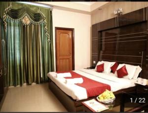a bedroom with a bed with a red blanket at Vipul Palace, katra in Katra