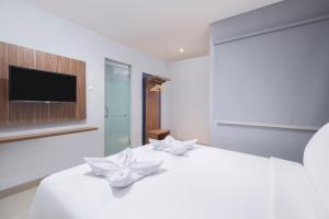 Voodi või voodid majutusasutuse Gold Hotel Simpang Lima toas