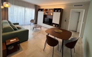 a living room with a couch and a table at Appartement Rue Grimaldi in Nice