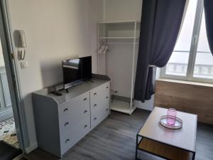 a living room with a dresser with a tv on it at La Fourmi in Soissons