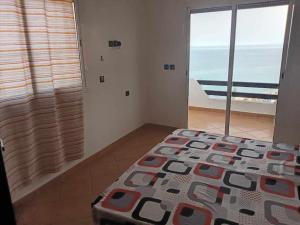 a bedroom with a bed and a view of the ocean at Villa The View in Tetouan