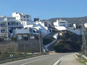 a road in front of white houses on a hill at Villa The View in Tétouan