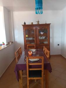 a dining room with a table with chairs and a cabinet at Villa The View in Tétouan