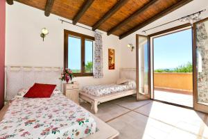 a bedroom with a bed and a large window at Villa Claudia in Castelvetrano Selinunte