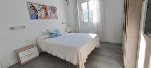 a small bedroom with a bed and a picture on the wall at Paula Beach Malaga in Málaga