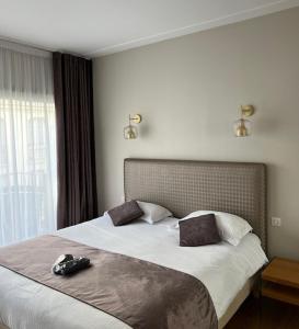 a bedroom with a large bed with shoes on it at Appartement Rue Grimaldi in Nice