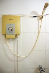a hose hooked up to a shower in a bathroom at Makers Guesthouse in Siem Reap