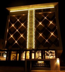 a night view of a building with lights on it at Paradigm Sarovar Portico in Kākināda