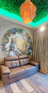 a couch in a room with a painting on the wall at LOFT DELUXE - MADRID RETIRO in Madrid