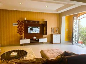 a living room with a couch and a flat screen tv at Rawdat Zayed Compound in Sheikh Zayed