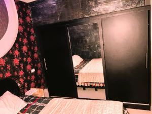 a bedroom with a mirror and a bed in it at Rawdat Zayed Compound in Sheikh Zayed