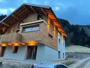 a house with a wooden roof on top of it at Chalet Cristal II in Les Contamines-Montjoie