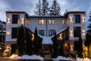 a house in the snow at night at Eden 1 & Eden 2 in Predeal