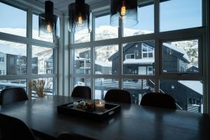 a dining room with a table and a large window at Stranda Fjellgrend - with jacuzzi & 3 bedrooms in Stranda