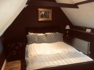 a bedroom with a bed in a attic at Cottonwood Barn in Goffs Oak