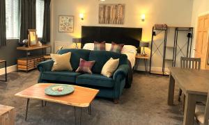 a living room with a couch and a bed at Elan Valley Hotel in Rhayader