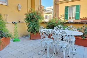 a white table and chairs on a patio at Amleto Apartments in Rome +50 photos