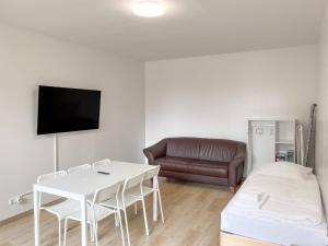 sala de estar con mesa blanca y sofá en T&K Apartments - Wegberg - 3-6 Zimmer Apartments, en Wegberg