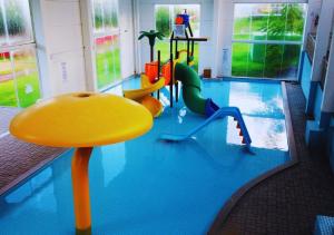 a swimming pool with two play equipment in it at Maestro Thermas Park Hotel in Francisco Beltrão