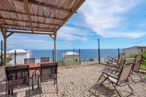a patio with a table and chairs and a view of the ocean at Lady Elena in Conca dei Marini