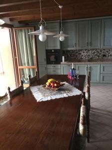 a kitchen with a table with a bowl of fruit on it at Casatragliulivi in Marone