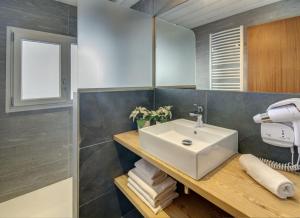 a bathroom with a sink and a mirror at Les Congères in Le Grand-Bornand