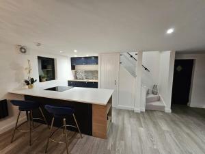 a kitchen with a counter and stools in a room at Relaxation & Romance in Manston +10 photos