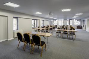 a room with rows of tables and chairs at Eden 1 & Eden 2 in Predeal