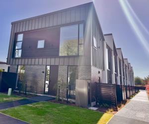 a house with a large window on the side of it at Urban Locale in Christchurch