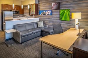 a living room with a couch and a kitchen at Residence Inn by Marriott Williamsport in Williamsport