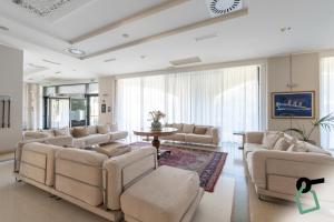 a large living room with couches and a table at HOTIDAY Hotel Otranto in Otranto