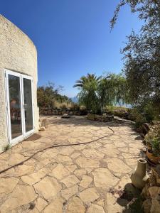 a large stone patio with a yard with a window at Casa Vista Panorámicas in Mojácar