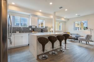 a kitchen with a large island with bar stools at Metro Horizon by AvantStay Rooftop Deck City View in Los Angeles